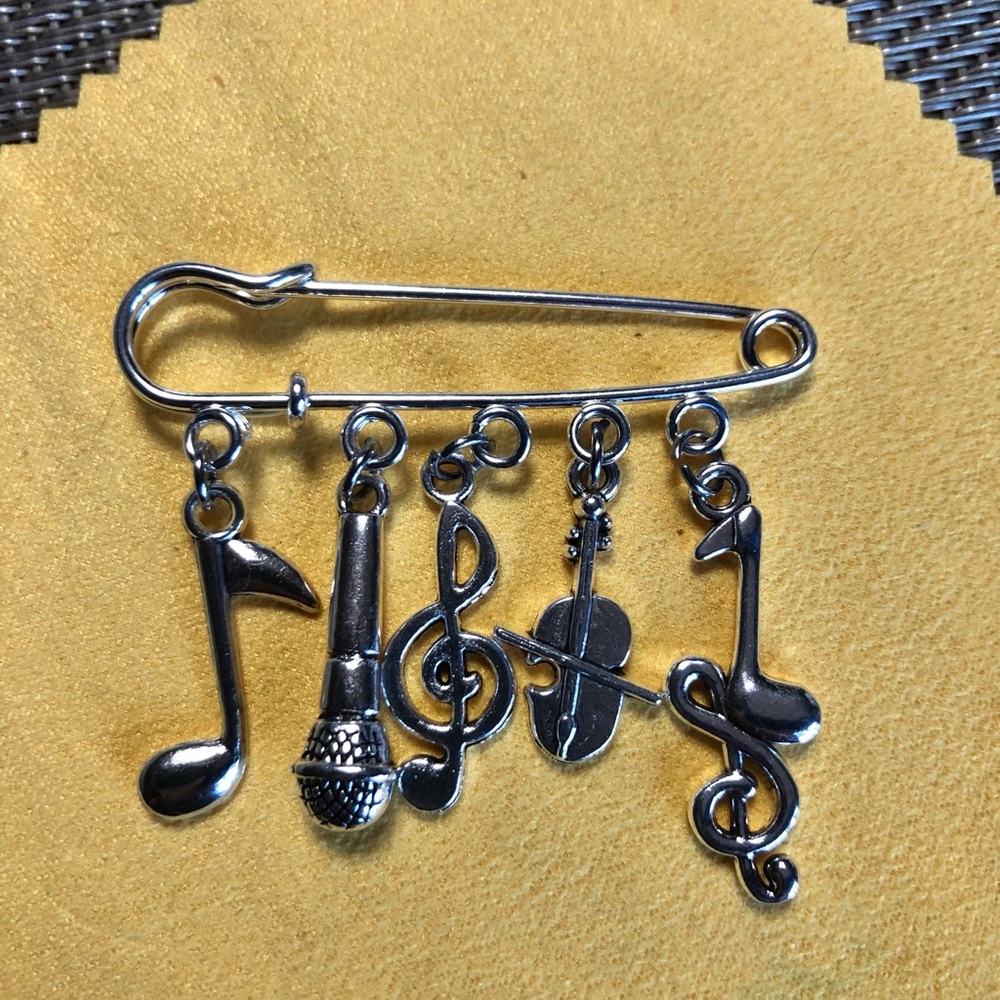 NWT, Handmade by A Charmed Life. Silver pin 🧷 with silver music 🎶 charms.